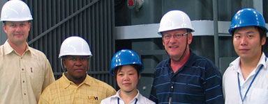 Rudi Coetzee and clients together with export personnel of JSHP in front of a 20 MVA transformer being type tested in the JSHP test centre